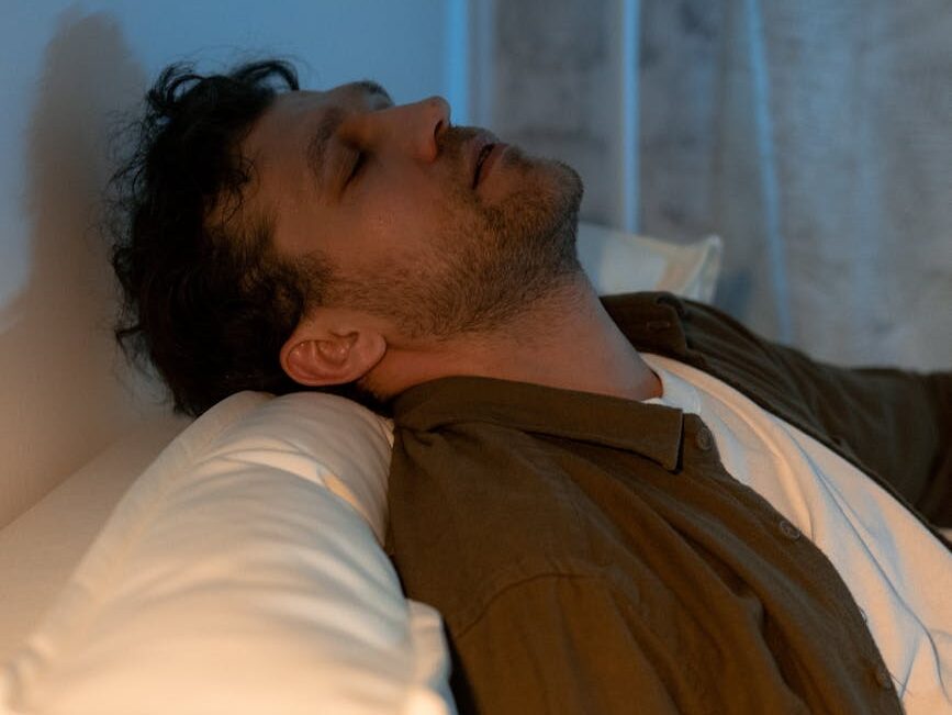a man sitting on a sofa sleeping